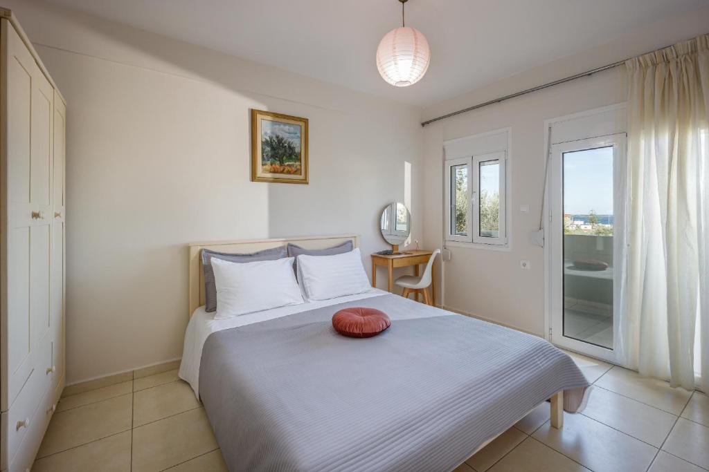 a bedroom with a bed with a red pillow on it at 4 Seasons villa-Sea view in Hersonissos
