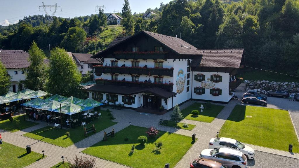 una vista aérea de un gran edificio con coches aparcados en un aparcamiento en Brandeberg Pension & Restaurant, en Bran