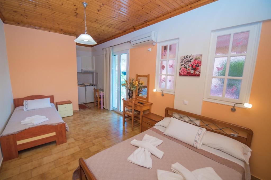 a bedroom with two beds in a room at Villa Ferendinoy - Ferendinoy Dionisia in Nydri