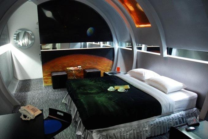 a room with a bed in a space ship at The Adventure Hotel in Chiang Mai