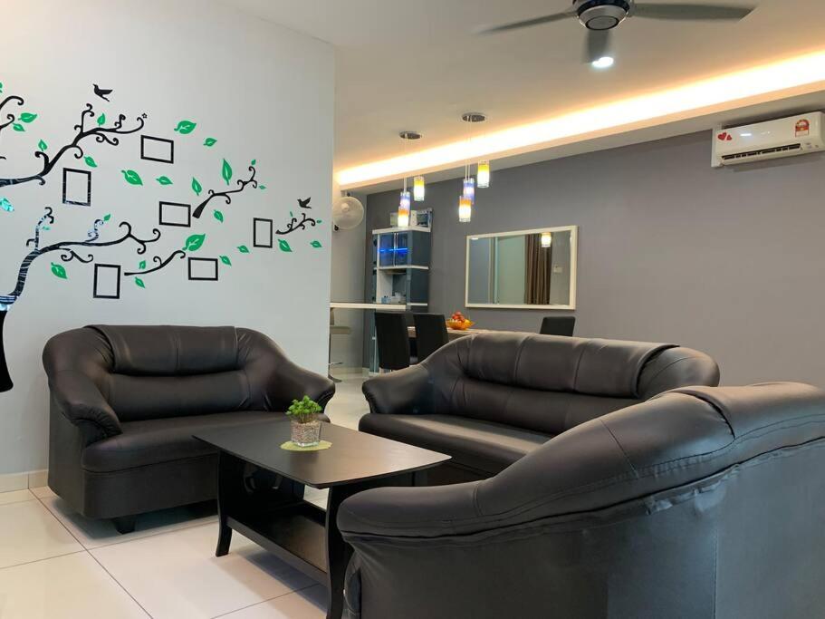 a living room with two couches and a tree on the wall at KS1 HOMESTAY SKY MIRROR DOUBLE STOREY HOUSE (4BR) in Kuala Selangor