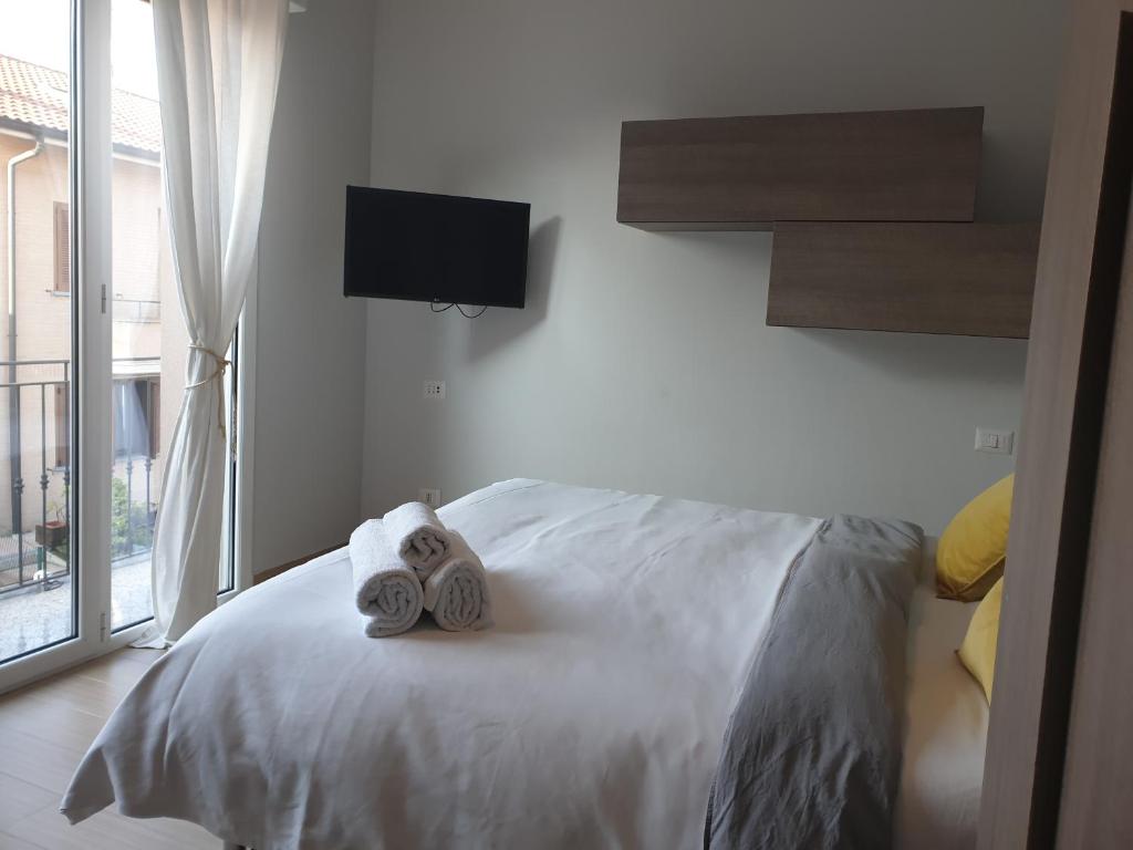 Postel nebo postele na pokoji v ubytování Michelangelo Apartments con parcheggio gratuito in loco e self check in