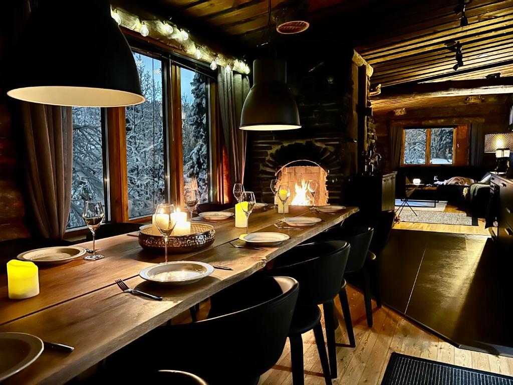 a long wooden table in a room with chairs and candles at Rukan Villa Kelotar (Mountain view) in Ruka