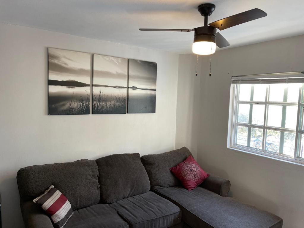 a living room with a couch and a ceiling fan at Otay 2 bedroom condo in Tijuana
