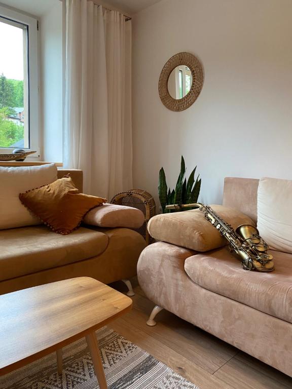 a living room with a couch and a table at mieszkanko_karkonoska in Jelenia Góra