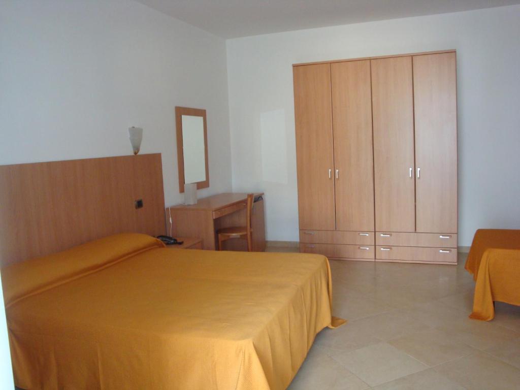 Postel nebo postele na pokoji v ubytování Hotel Maggiore