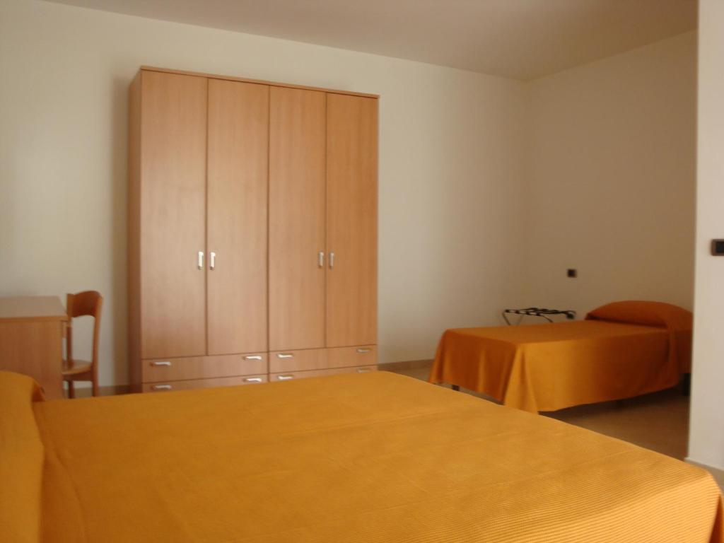Postel nebo postele na pokoji v ubytování Hotel Maggiore