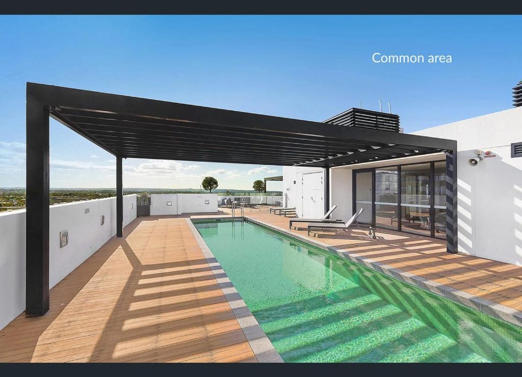 a swimming pool on the roof of a house at Modern Spacious City Pad with Rooftop Pool and Gym in Sydney