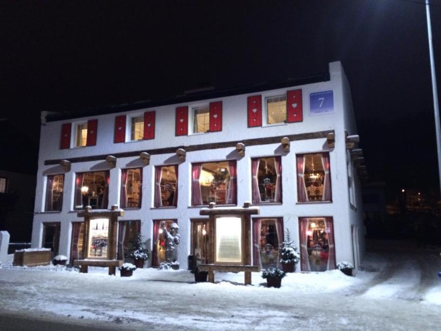 a white building with a lot of windows in the snow at POD TĘŻNIĄ in Szczyrk