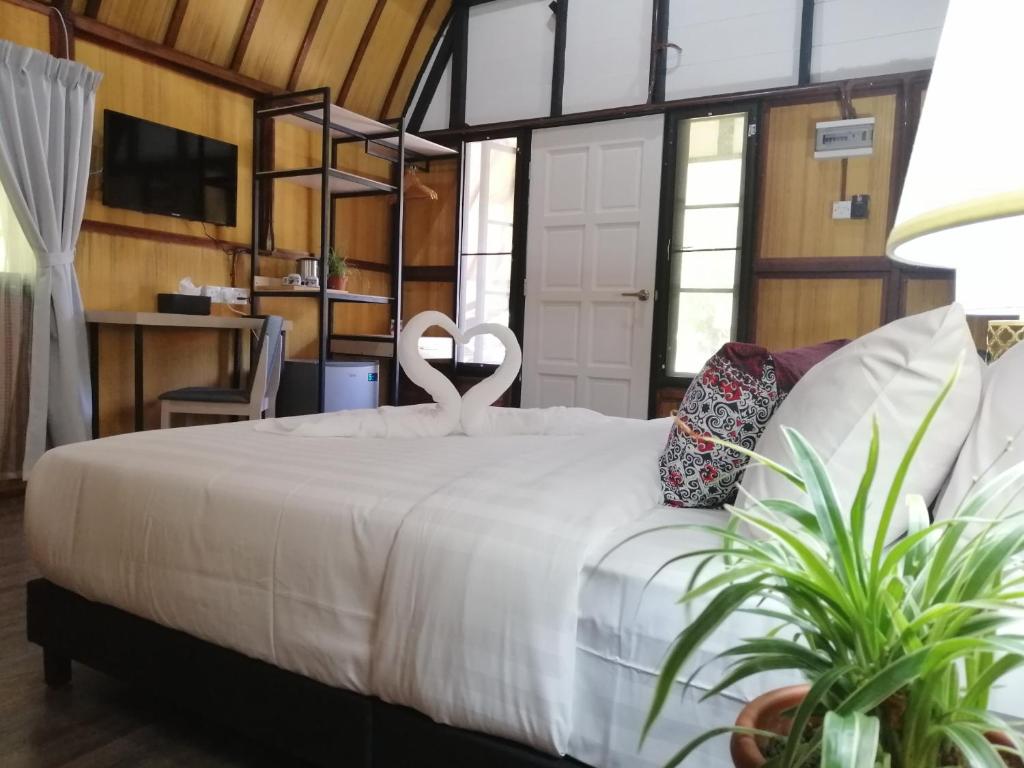 Postel nebo postele na pokoji v ubytování Api-api Eco Chalet