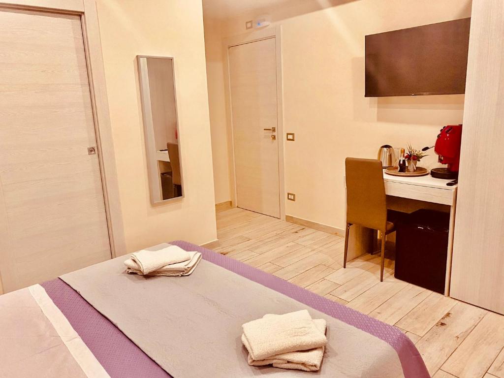Postel nebo postele na pokoji v ubytování YourHome - La Meta Perfetta Rooms&Spa