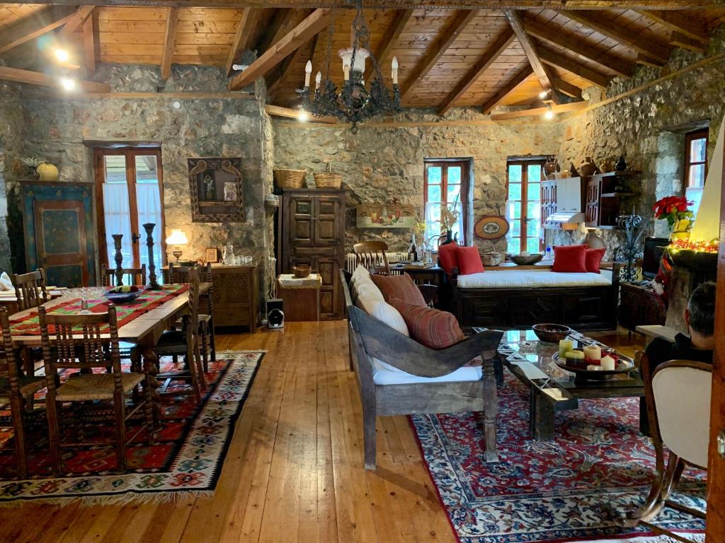 a living room with a couch and a table at MARIOLATA STONE HOUSE in Lílaia