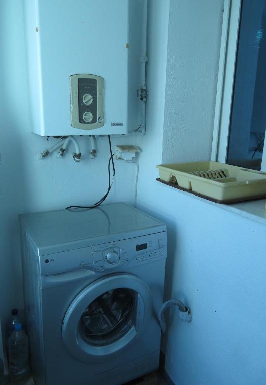 a washing machine in a bathroom with a mirror at Beautiful appartment with a glorious sea view in Monastir