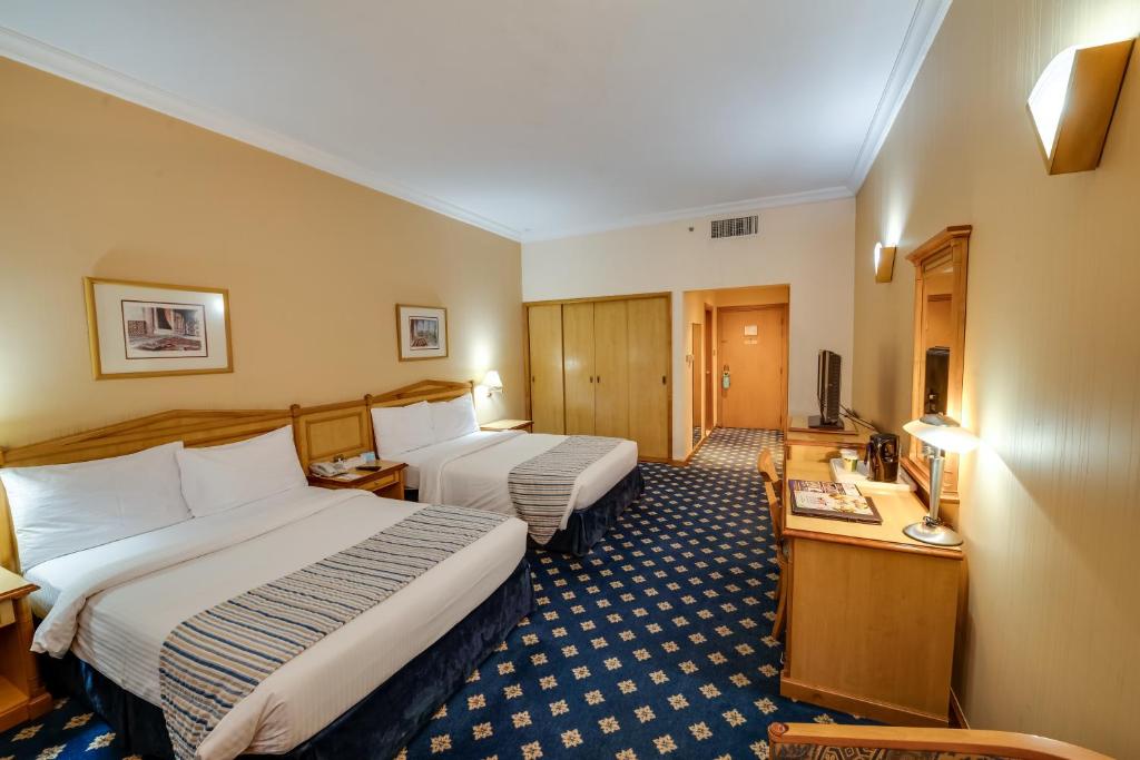 En eller flere senger på et rom på Grand Continental Hotel