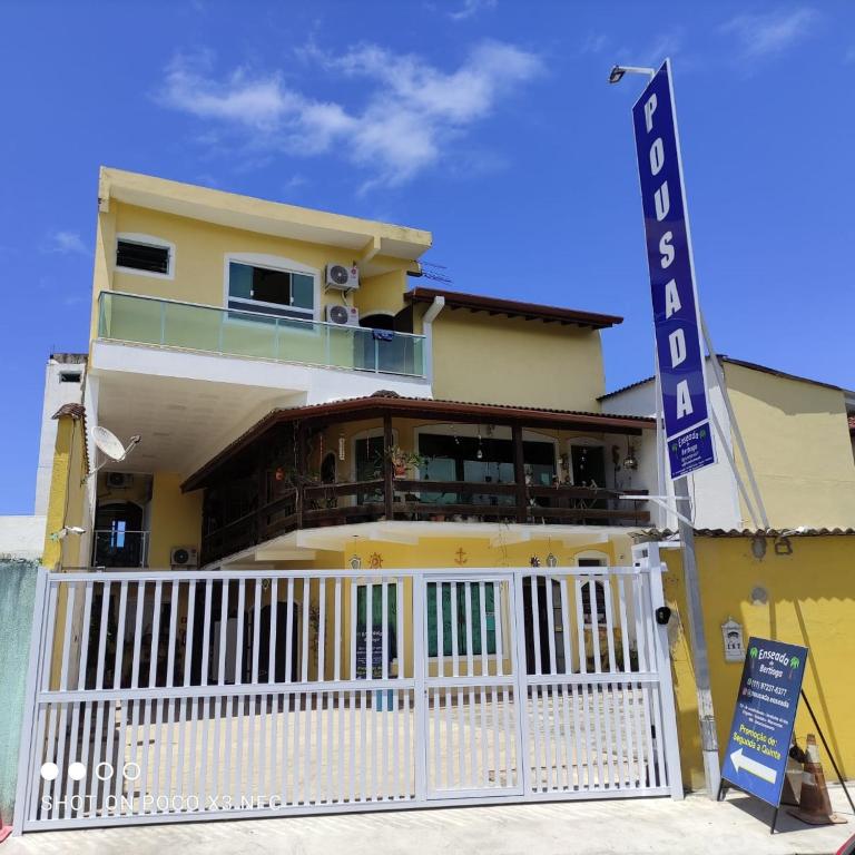 a yellow building with a sign in front of it at Pousada Enseada de Bertioga in Bertioga