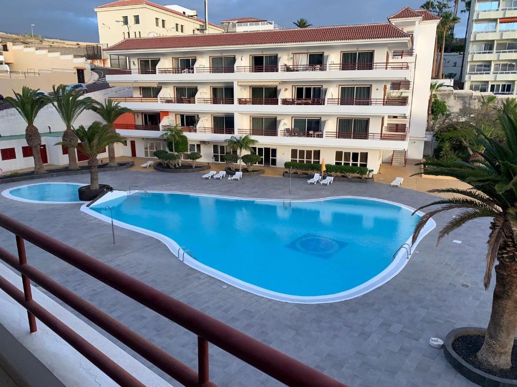 a large swimming pool in front of a building at Tagara in Puerto de Santiago