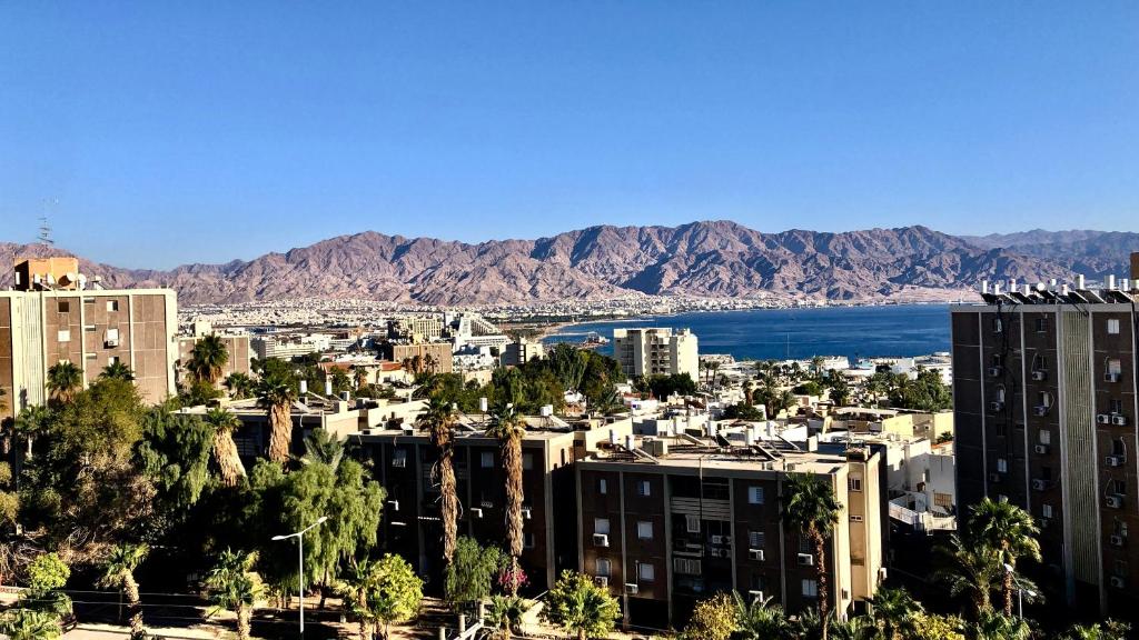 a view of a city with mountains and a body of water at 123Eilat tzofit in Eilat