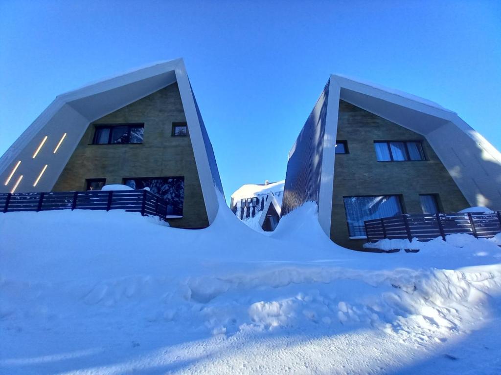 a building in the snow with snow around it at Olympic Oasis in Jahorina