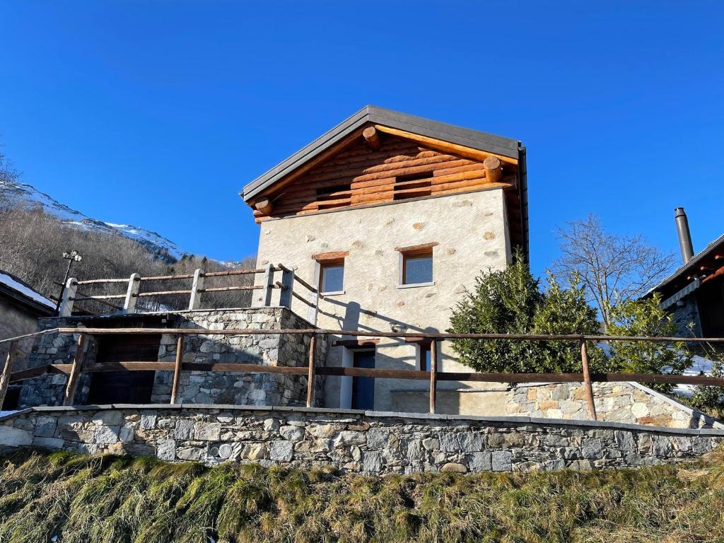 una casa en la parte superior de una pared de piedra en CHALET ARMONIOSO, en Leontica