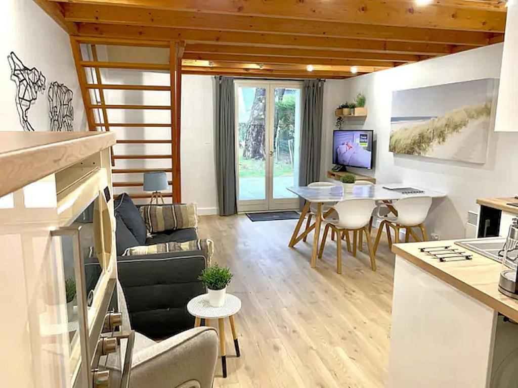 a living room with a couch and a table at Cottage T3 à 5 minutes à pied de la plage in Le Pouliguen