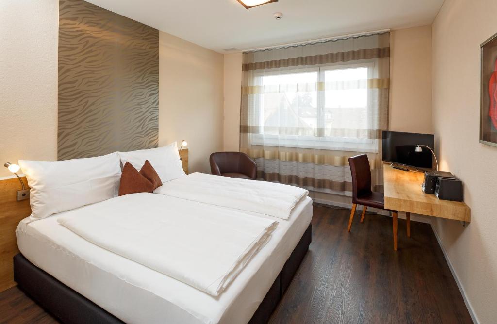 Ein Bett oder Betten in einem Zimmer der Unterkunft Villmergen Swiss Quality Hotel