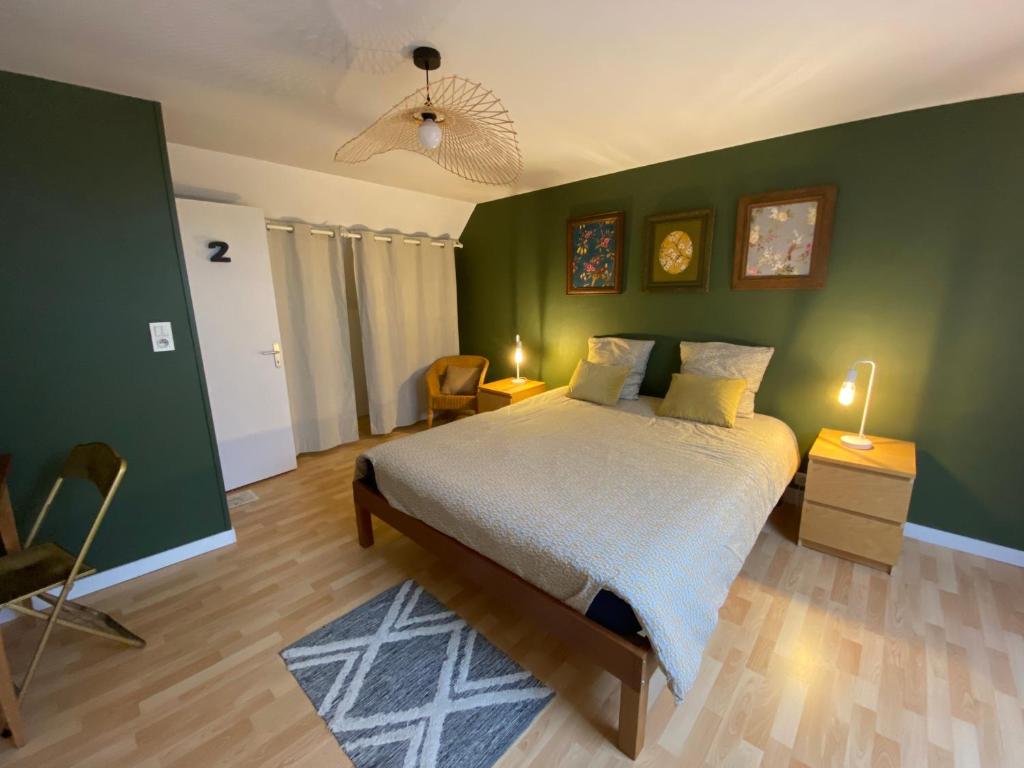 - une chambre avec un lit et un mur vert dans l'établissement Gîte À bon port Abbeville 5 personnes, à Abbeville