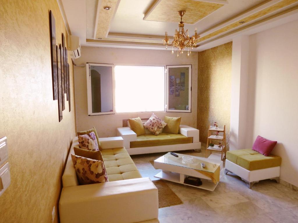a living room with a couch and a chair at Beautiful appartment with a glorious sea view in Monastir