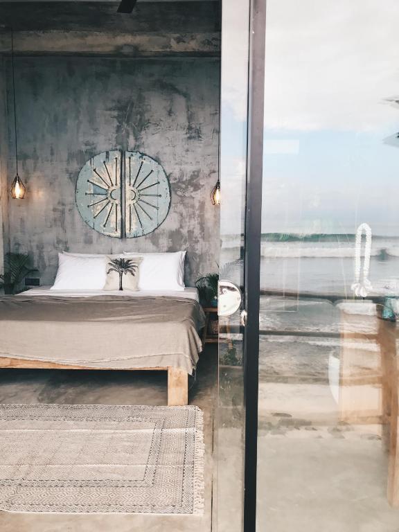 a bedroom with a bed and a view of the ocean at Morena Boutique Hotel Weligama in Weligama