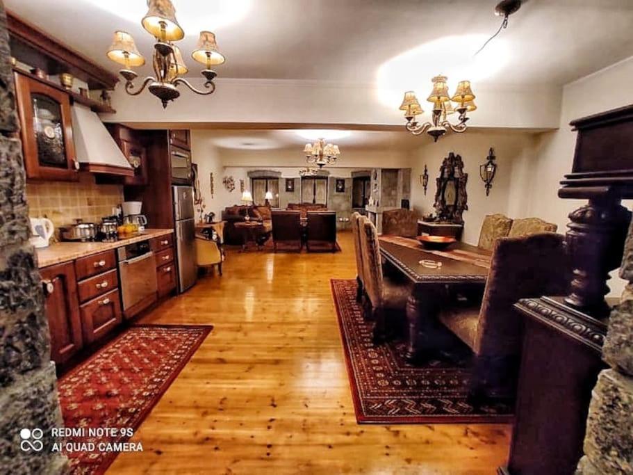 a kitchen and living room with a table and chairs at Archontiko-Vytina in Vitina