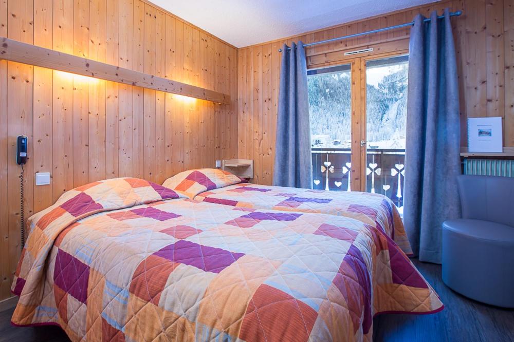 Postel nebo postele na pokoji v ubytování Hotel Les Lans