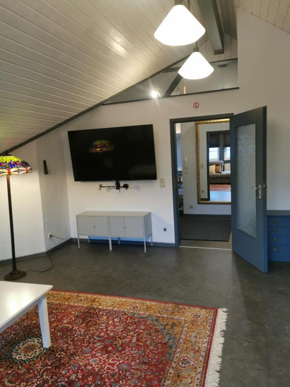 a living room with a large flat screen tv on the wall at Rimvydas Apartment in Winterberg