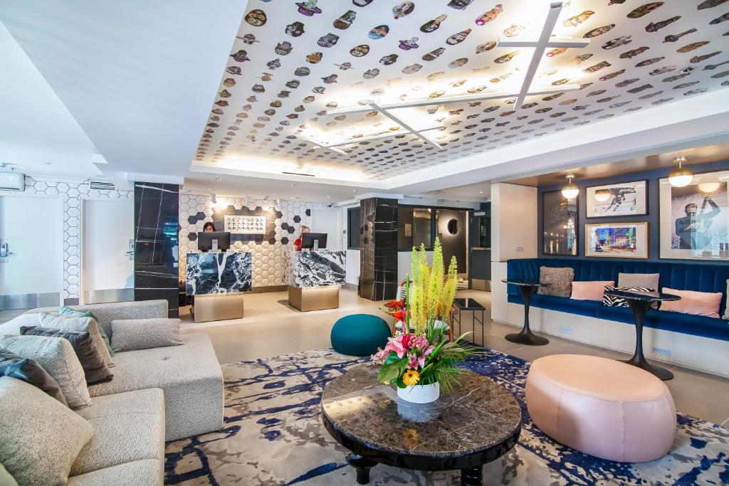 a living room with a couch and a table at Hotel Belmont Vancouver - MGallery Collection in Vancouver