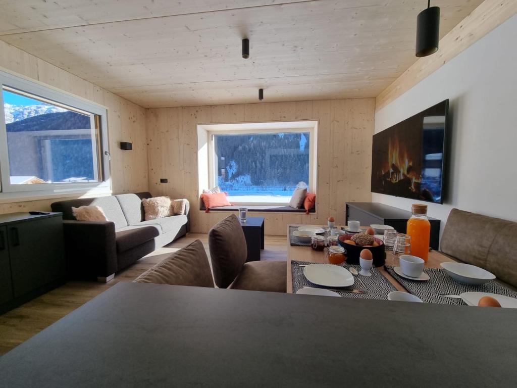 a living room with a couch and a table with chairs at Haus Wally in Neustift im Stubaital