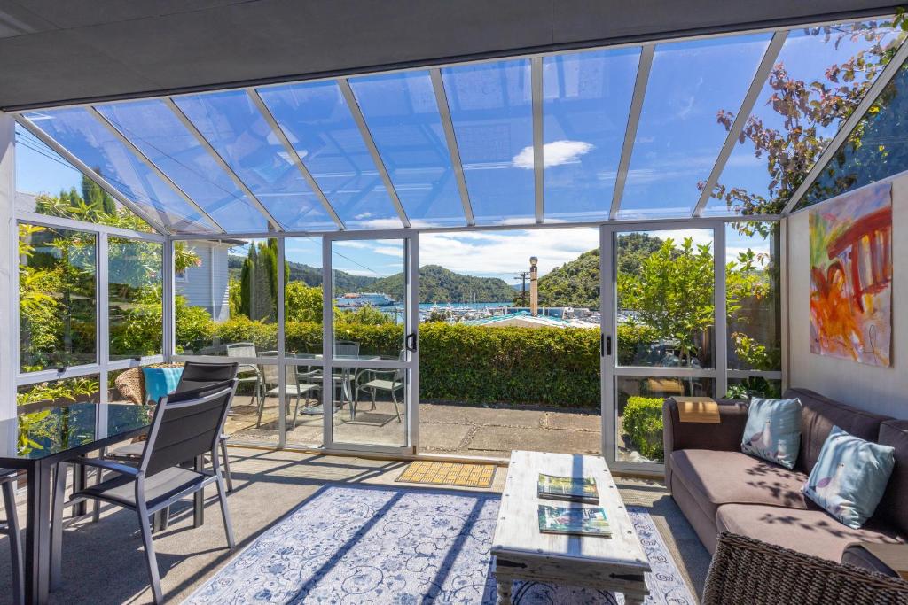 a glass house with a view of the water at Seaview Apartment in Picton
