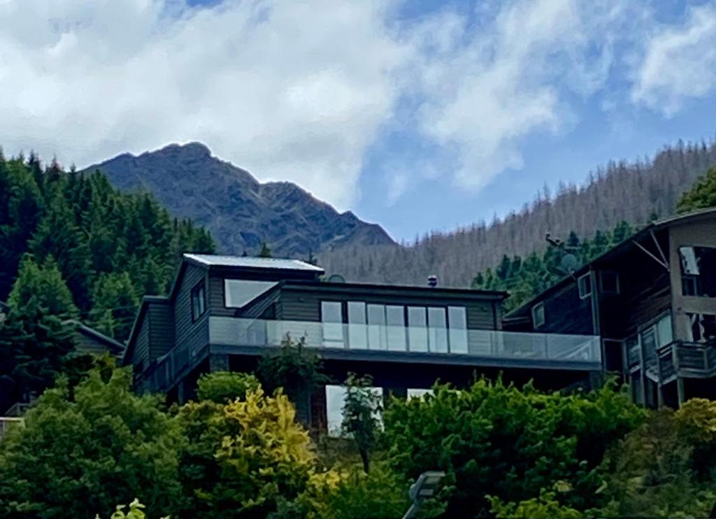 a large house with a view of a mountain at Queenstown Lake Panorama in Queenstown