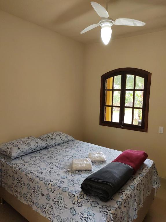 um quarto com uma cama e uma ventoinha de tecto em Suíte na Montanha em Trindade