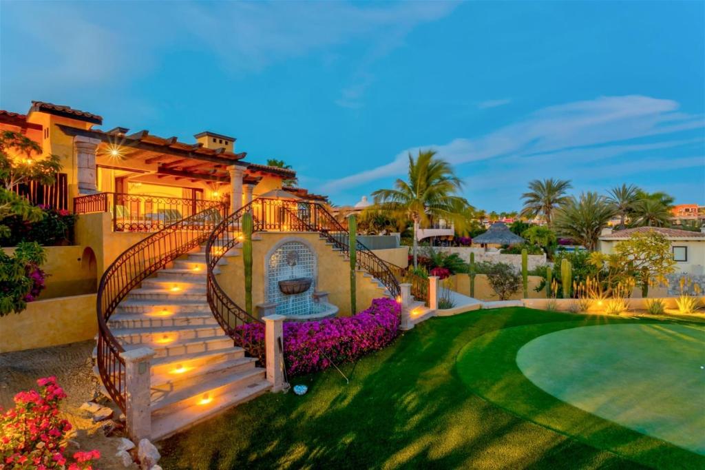 a house with a staircase leading to a yard at Villa Gracia in Cabo San Lucas