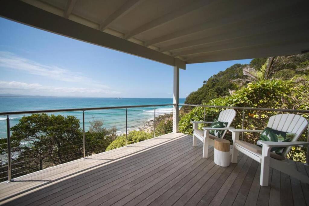 a deck with two chairs and a view of the ocean at Fuller Holidays - Jane's on Wategos Unit 2, 37 Marine Pde-2 Bed Villa in Byron Bay