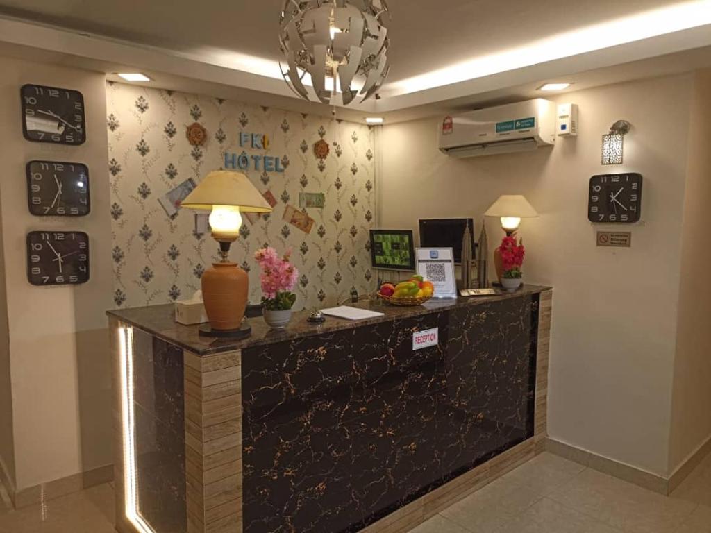 a reception desk in a hotel lobby with a lamp at FKI INTERNATIONAL HOTEL in Kuala Lumpur