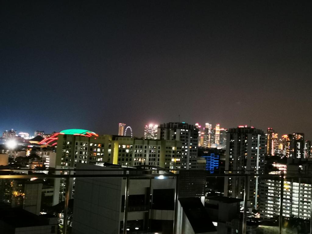a view of a city skyline at night at Master Bedroom with toilet in Singapore