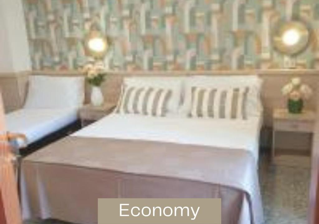 A bed or beds in a room at Hotel Alexandra - Beach Front - Healthy XXL Breakfast & Brunch until 12 30 - parking included