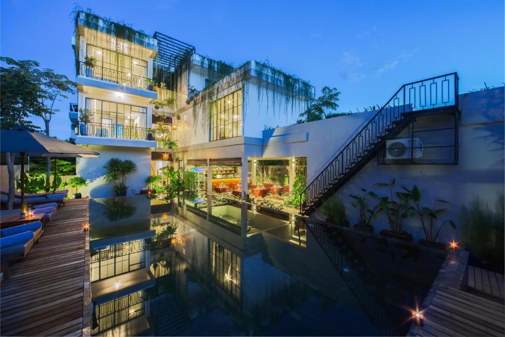 a house with a swimming pool at night at Vihara The City of Temples in Siem Reap