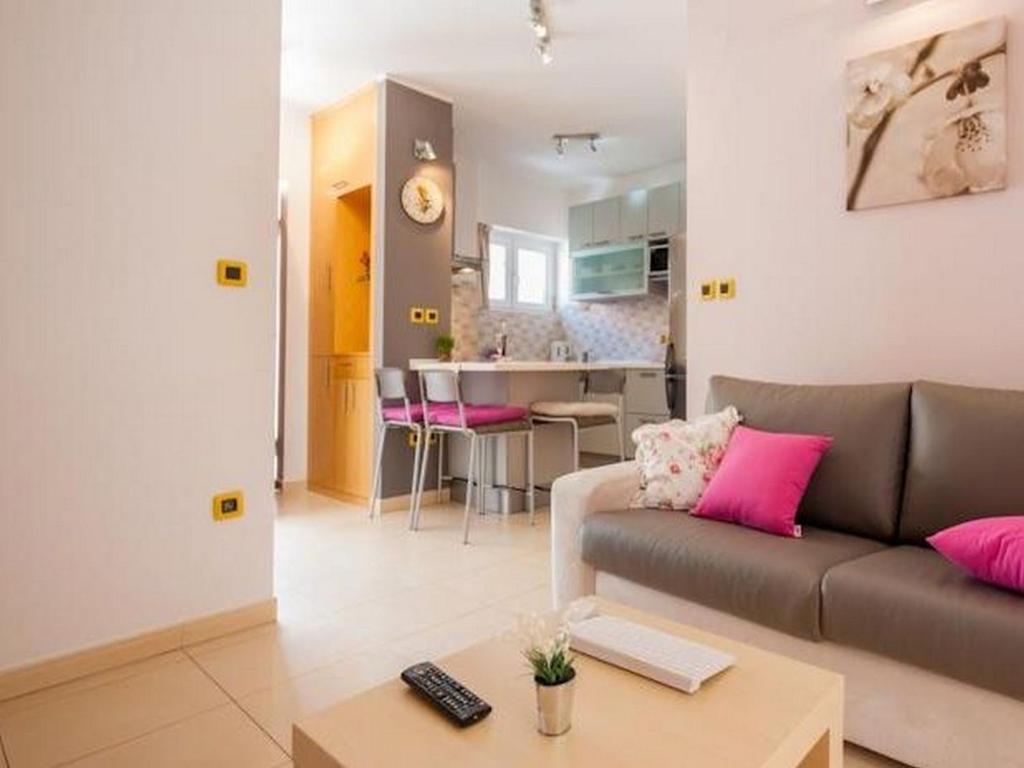 a living room with a couch and a table at Aldo Apartments Center in Zadar