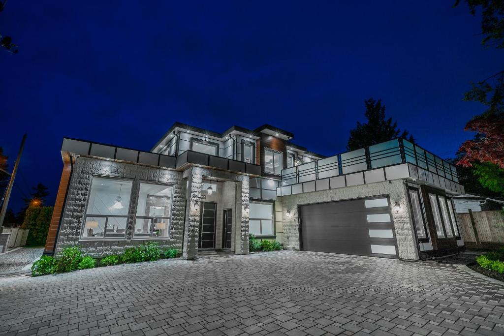 a large house with a garage at night at Sun suite in Surrey