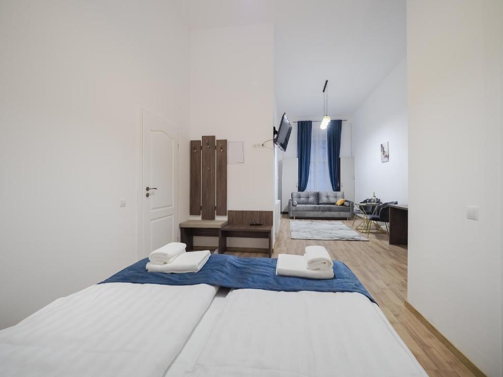 a bedroom with a large bed with blue sheets at ELISABETH HOME Piata Mare in Sibiu