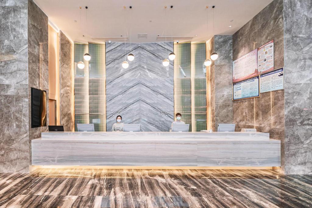 a lobby of a hotel with a reception desk at Atour Hotel Luzhou Bubugao New World in Luzhou