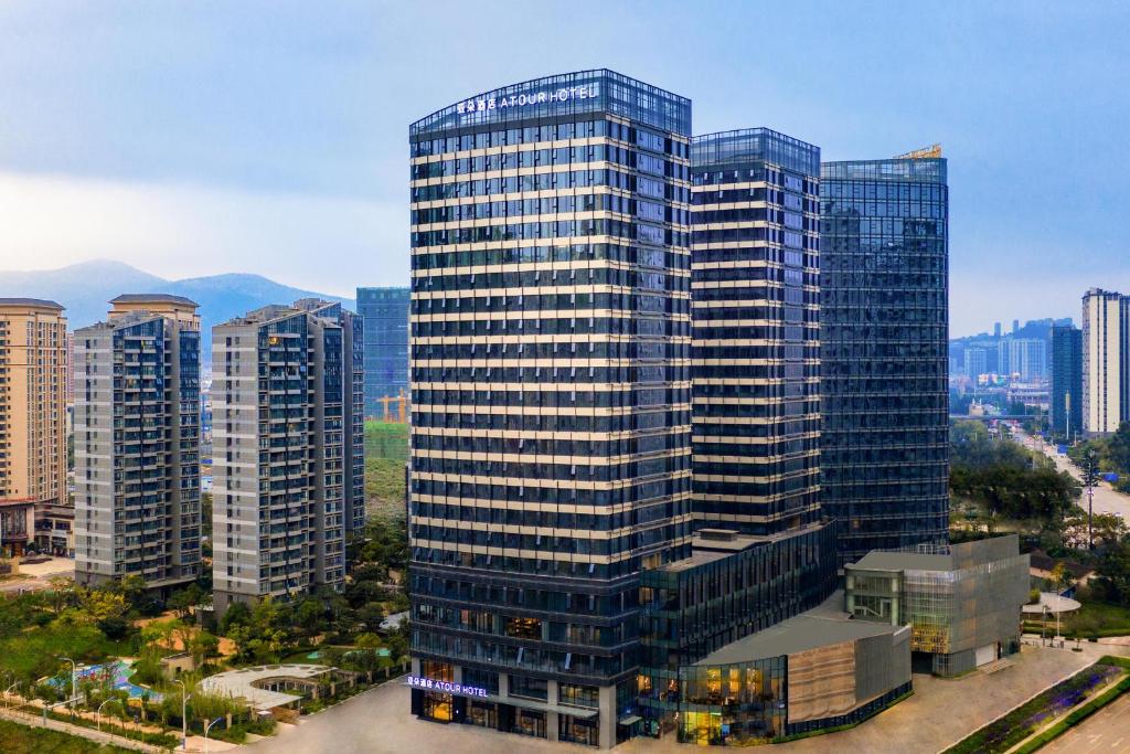 a tall building with many windows in a city at Atour Hotel Kunming Hi-tech Wuyue Plaza in Kunming