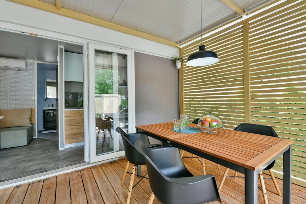 a dining room with a wooden table and chairs at Polidor Camping Resort in Poreč