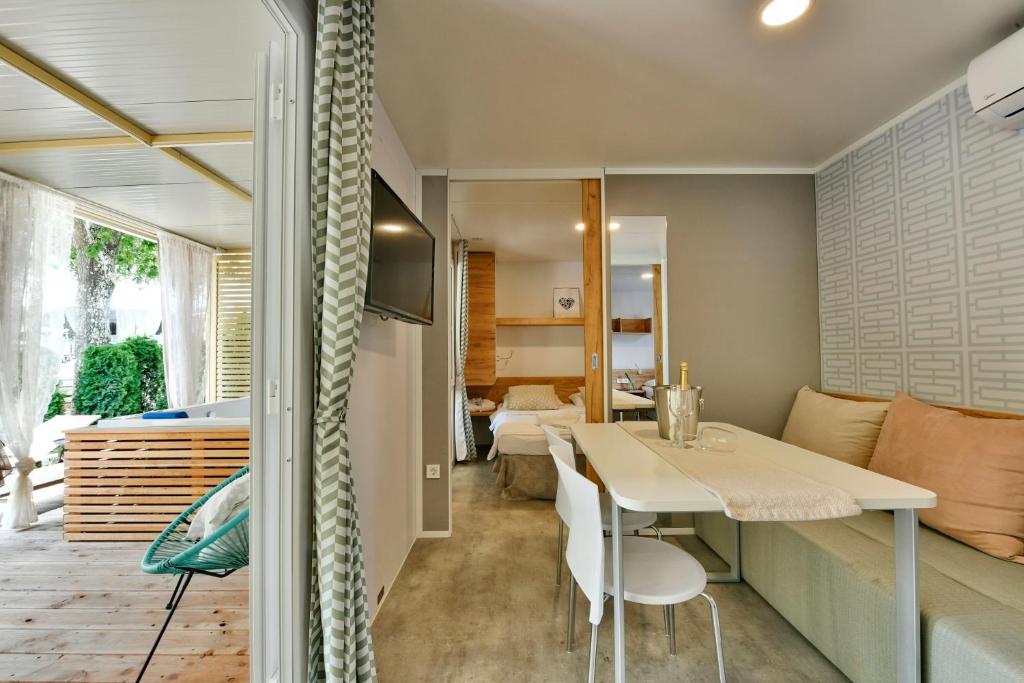 a kitchen and living room with a table and chairs at Polidor Camping Resort in Poreč