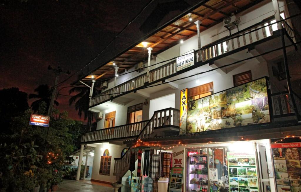 ein Gebäude mit zwei Balkonen darüber in der Nacht in der Unterkunft Sunny Mood Guest House in Unawatuna